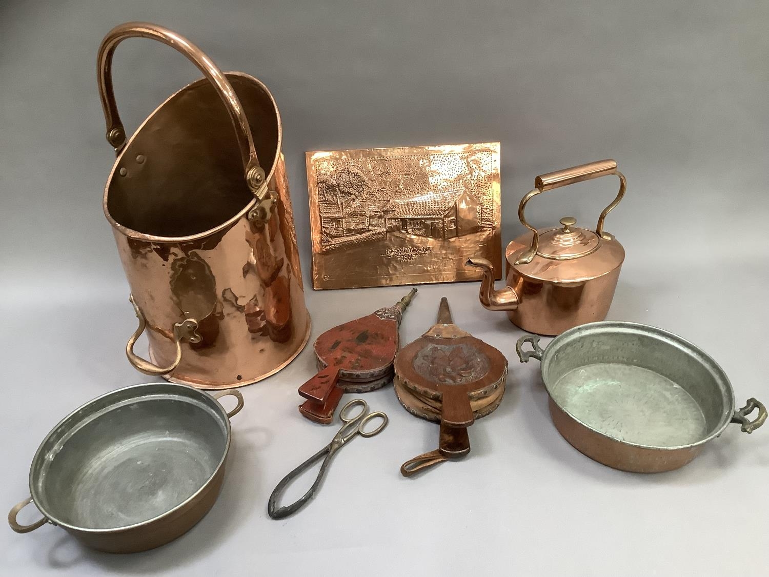 A copper coal hod, two coppered tin dishes, copper kettle of oval outline, two copper chestnut