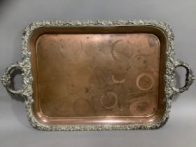 A Victorian plated on copper two handled tray, the rim cast with fruiting leafage and flowerheads,