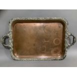 A Victorian plated on copper two handled tray, the rim cast with fruiting leafage and flowerheads,