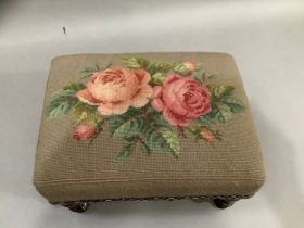 A Victorian footstool of rectangular outline with rose needlework cover, turned mahogany legs, 30.