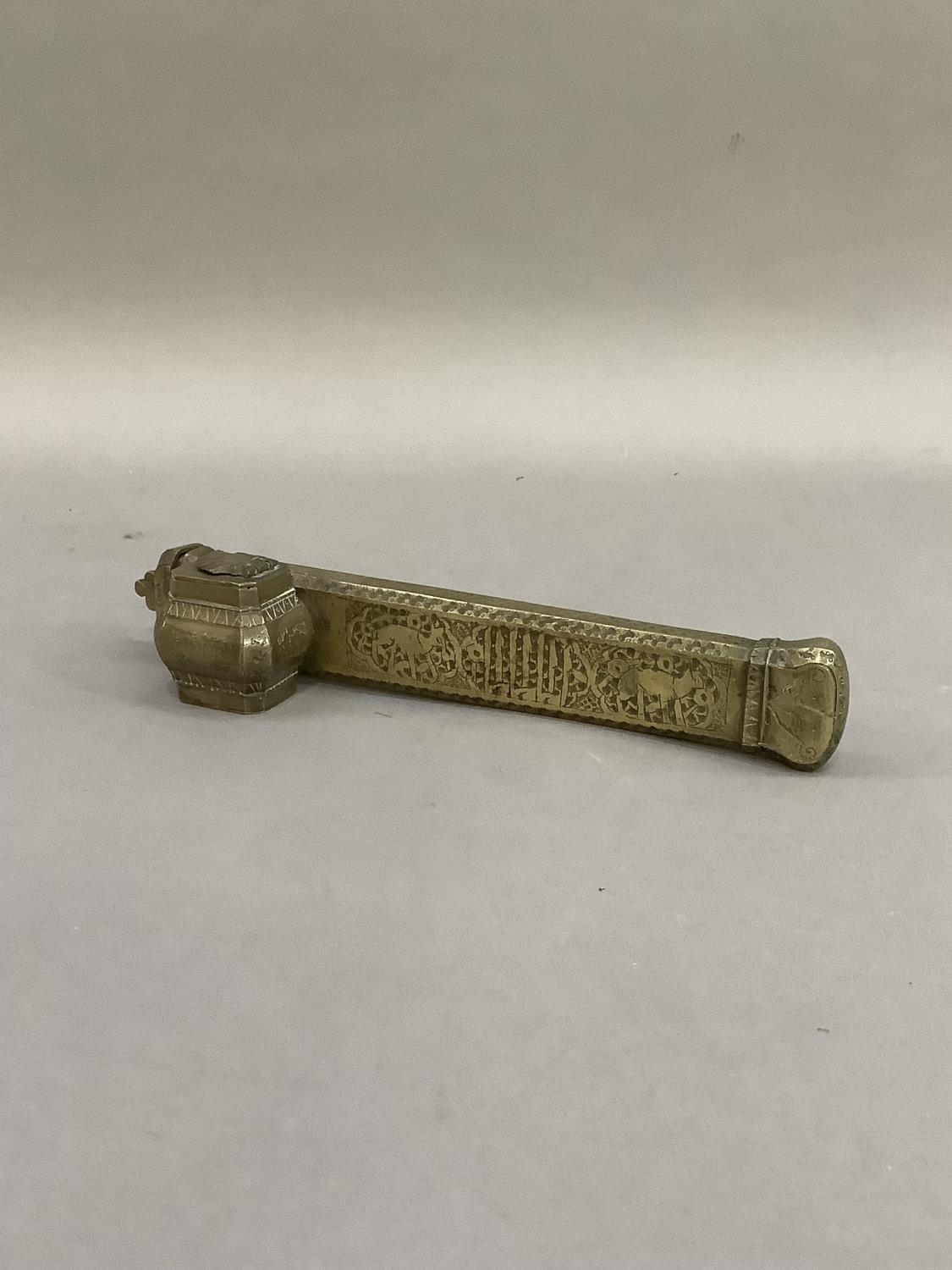 A Middle Eastern brass scribe's pen and inkwell holder, 25cm long