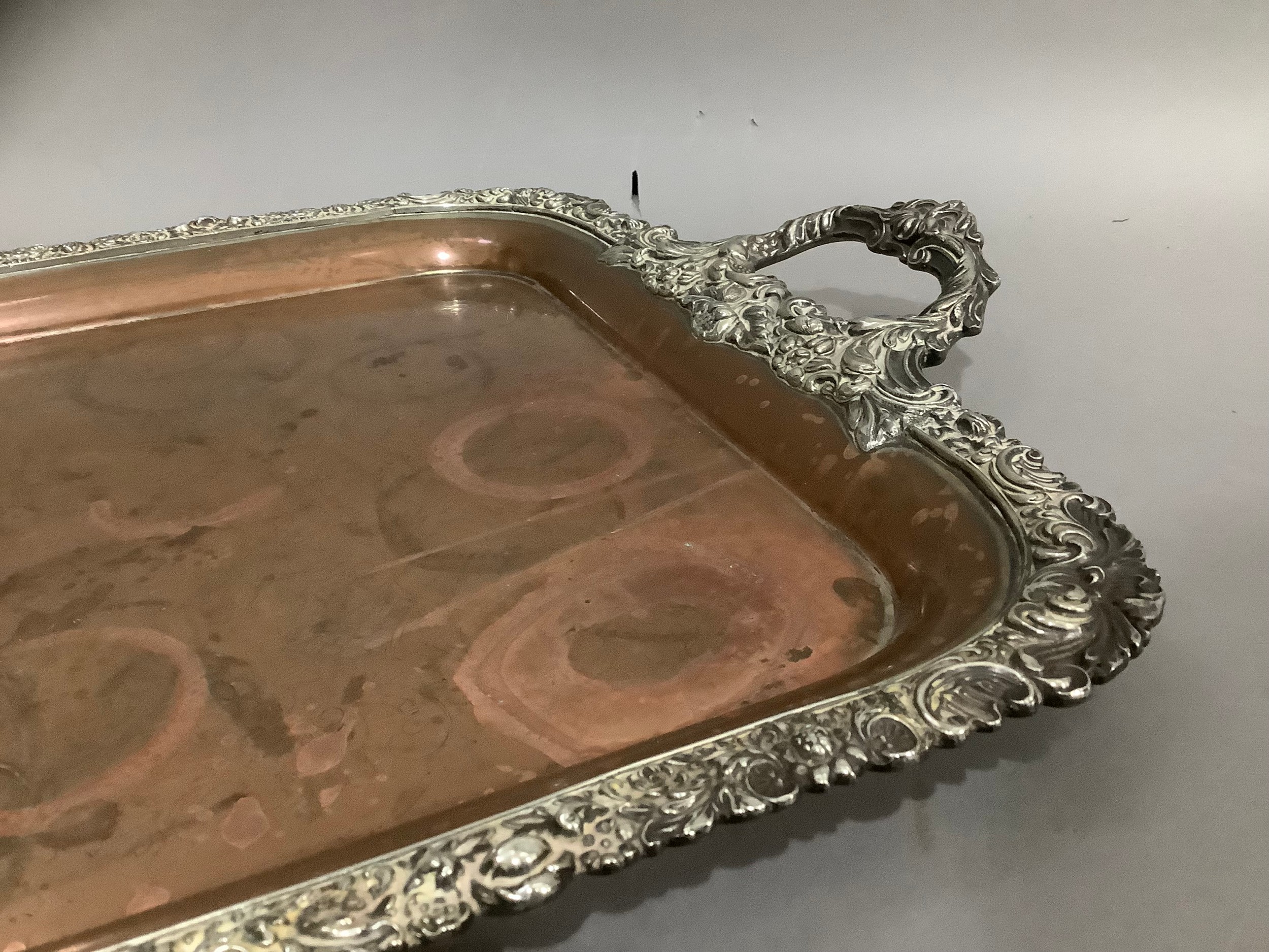 A Victorian plated on copper two handled tray, the rim cast with fruiting leafage and flowerheads, - Image 2 of 2