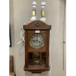 A 1930s oak wall clock having a silvered dial with black Arabic numerals, eight day striking