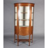 An Edward VII mahogany and satinwood bow fronted display cabinet, crossbanded, having a moulded