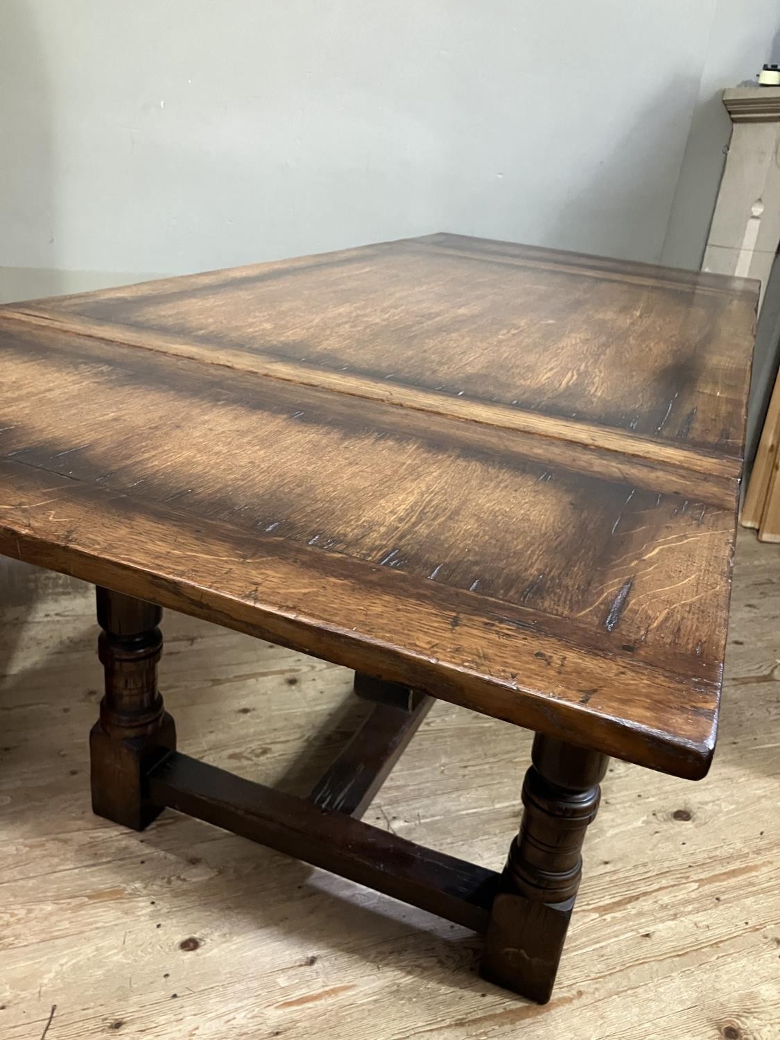 A Titchmarsh and Goodwin oak drawer leaf extending dining table on turned legs joined by an 'H' - Image 3 of 6