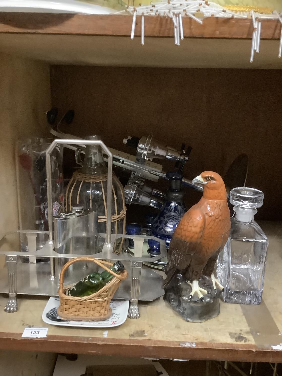 A set of optics on chrome stand, a Pimm's jug and stirrer, a Tia Maria ice box, a silver plated