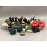 An Avon Pheasant Tai Winds aftershave bottle, another Avon aftershave bottle, two moulded green gass