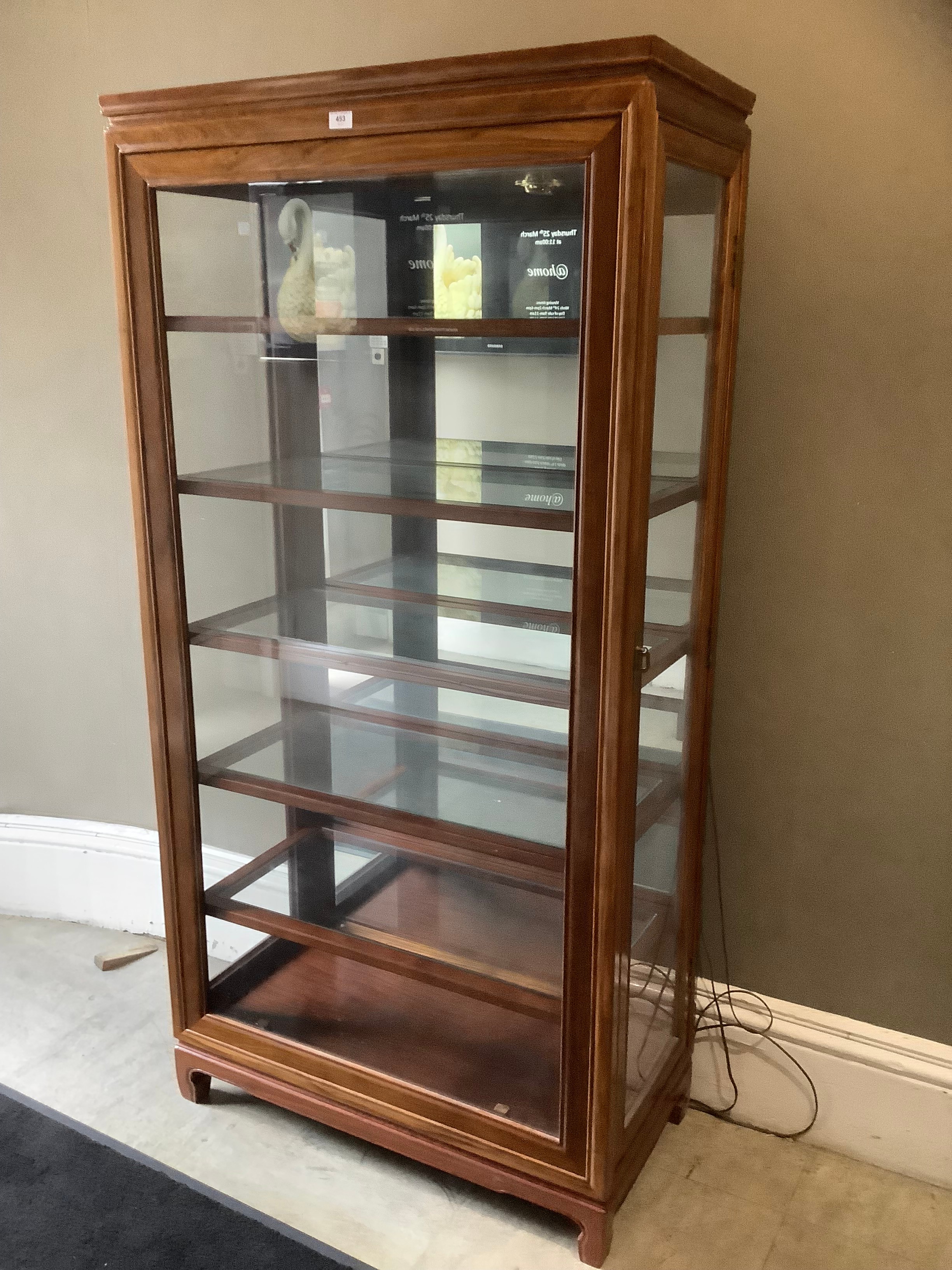 A Chinese teak and glazed display cabinet of five shelves with side opening doors, 191cm wide x