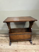 An oak magazine rack- table on shaped standards, 51cm wide