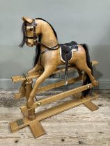 A child's beech rocking horse by White Horse Company on turned pillars and cross platform