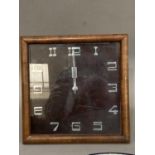 An Art Deco walnut mantle clock of square outline with chrome Arabic numerals and hands, with back