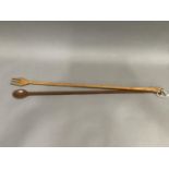 A long handled treen fork and spoon, 76cm length