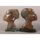 Two early 20th century bronze profiles of an African tribesman and woman, after Hagenau, coppered