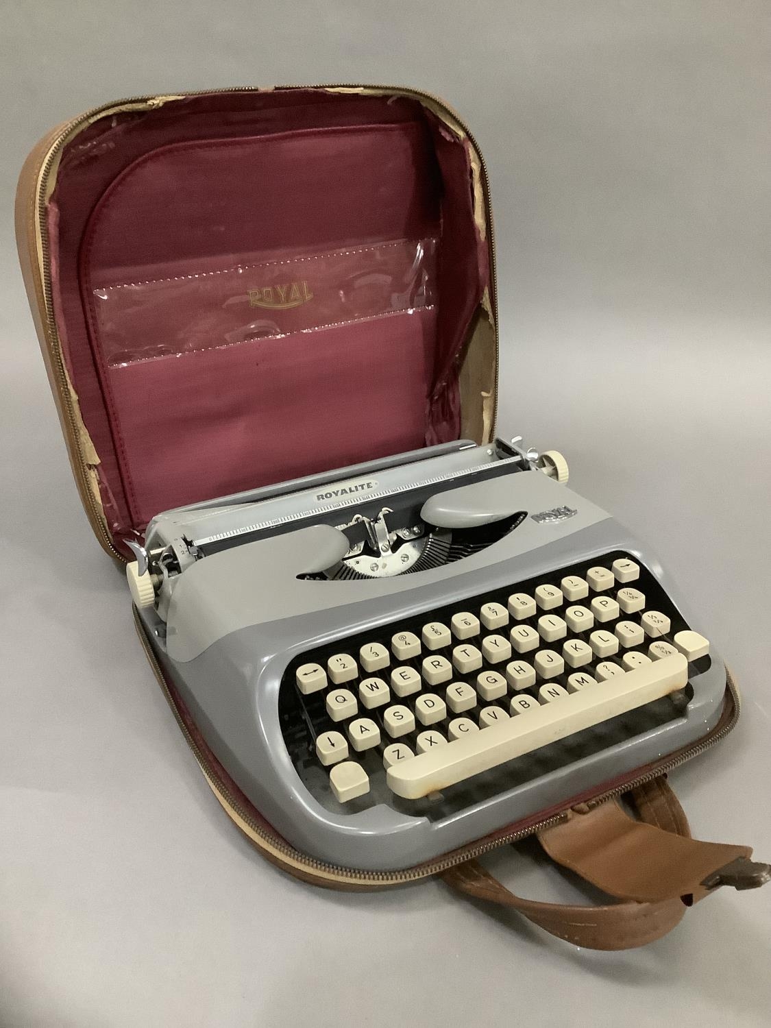 A vintage typewriter by Royalite in two tone grey metal frame and with carrying case