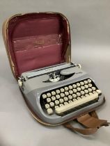 A vintage typewriter by Royalite in two tone grey metal frame and with carrying case