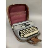 A vintage typewriter by Royalite in two tone grey metal frame and with carrying case