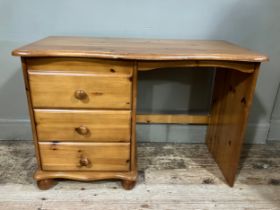 A modern pine desk with bank of drawers