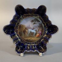 A 19th century Royal Vienna dish of fluted hexagonal outline, hand painted to the well with a
