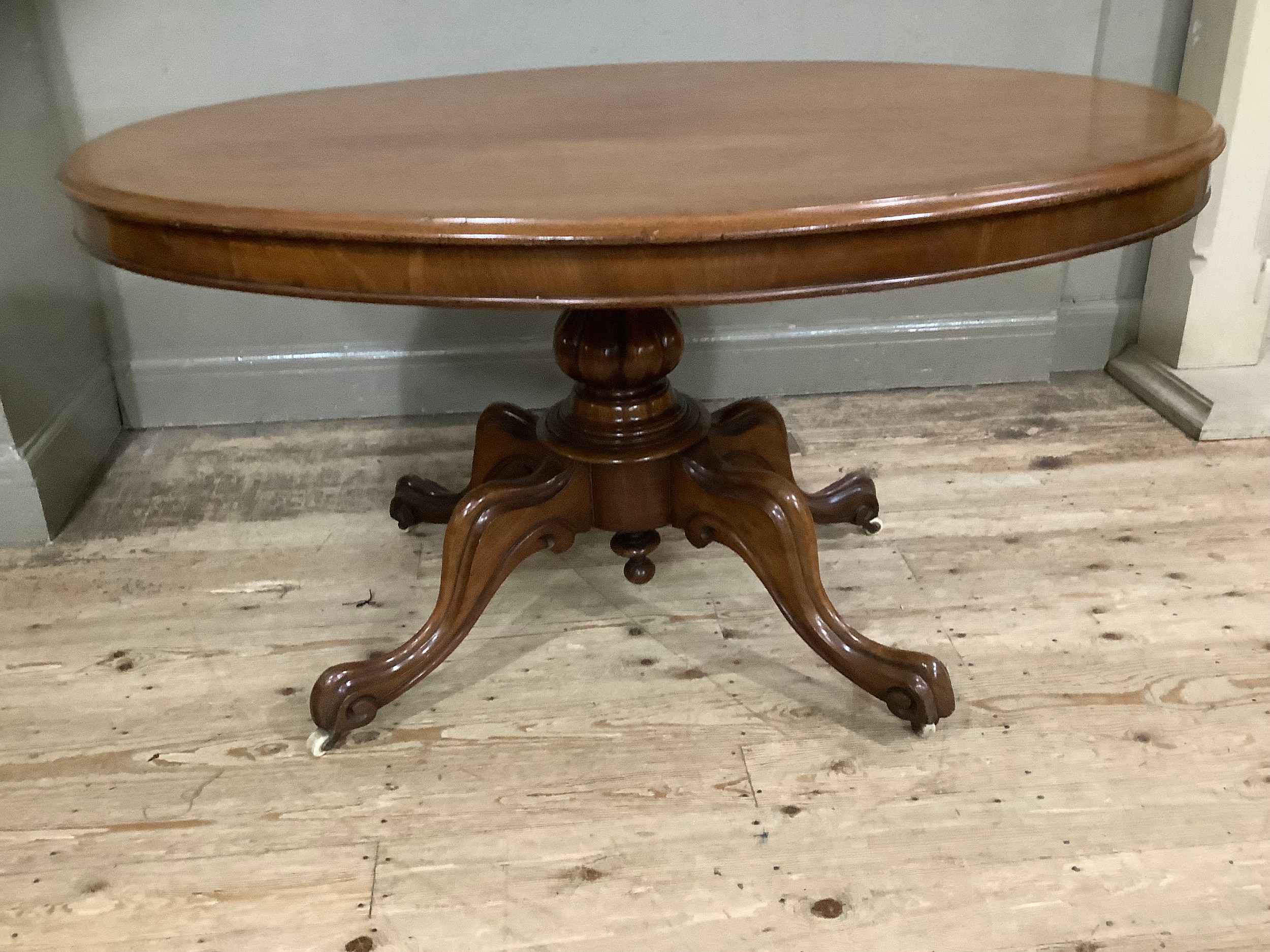 A mahogany Victorian oval Looe table on carved baluster column on four moulded cabriole legs with - Image 2 of 4