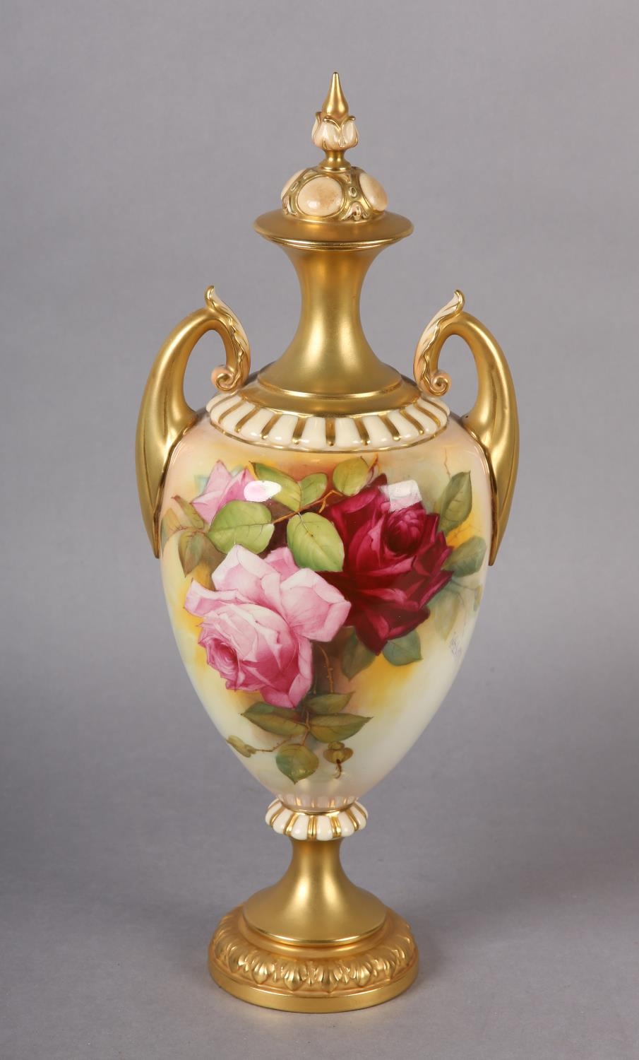 A Royal Worcester urn-shape vase and over painted by W H Austin with red and pink roses, signed