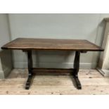 An oak refectory dining table on shaped standards and platform stretcher, 150cm x 74cm