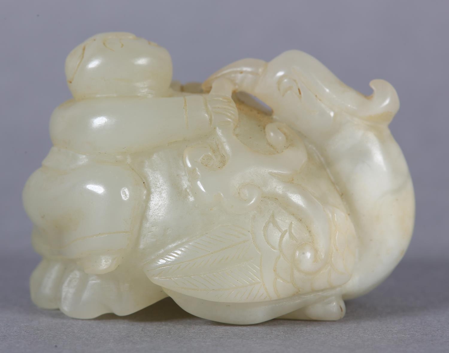 A Chinese jade carving of a boy climbing upon the back of a phoenix with its head turned backwards - Image 3 of 8