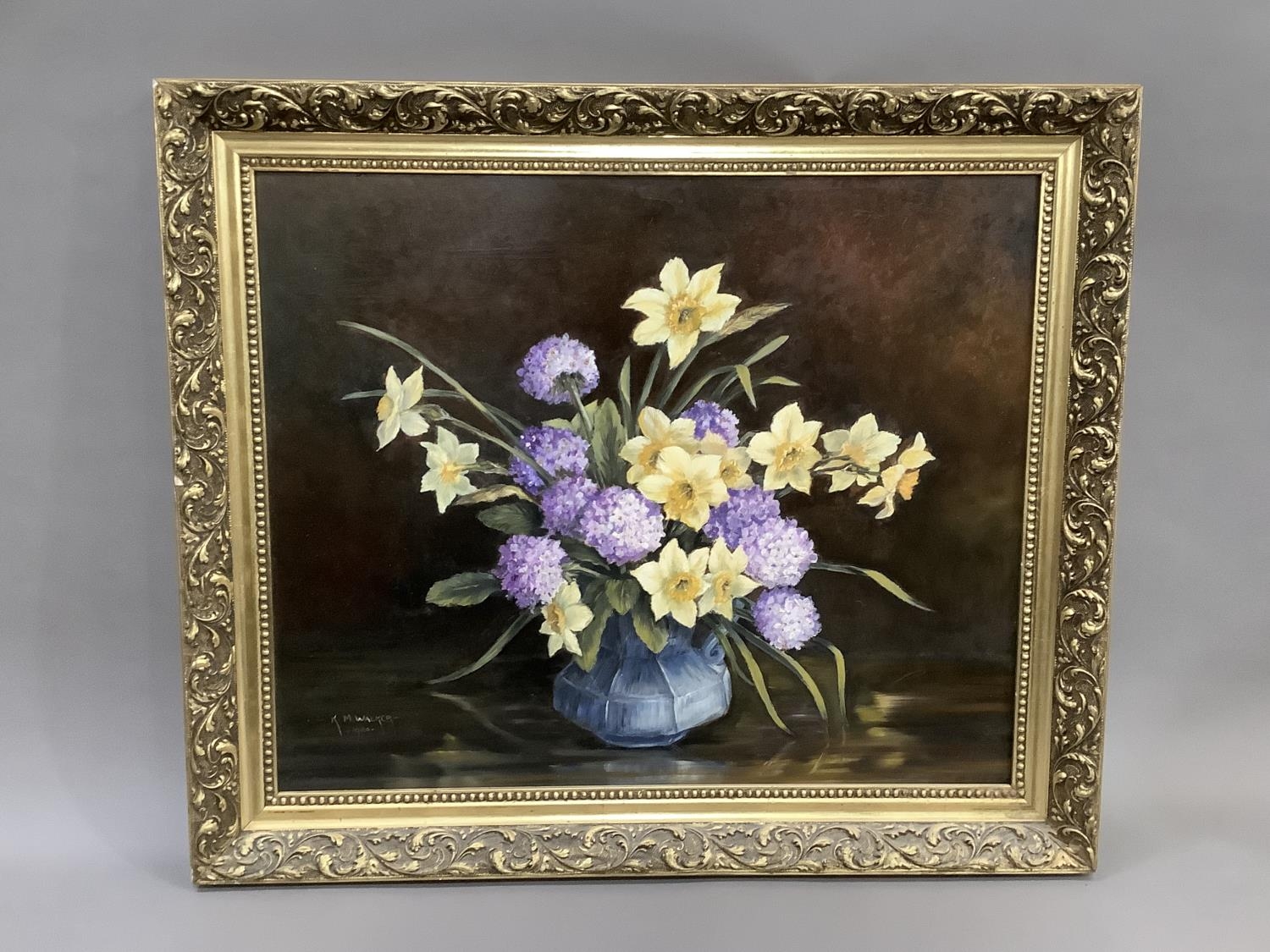 K.N. Walker still life of daffodils and primula pom-poms held in a pottery jug, oil on board, signed