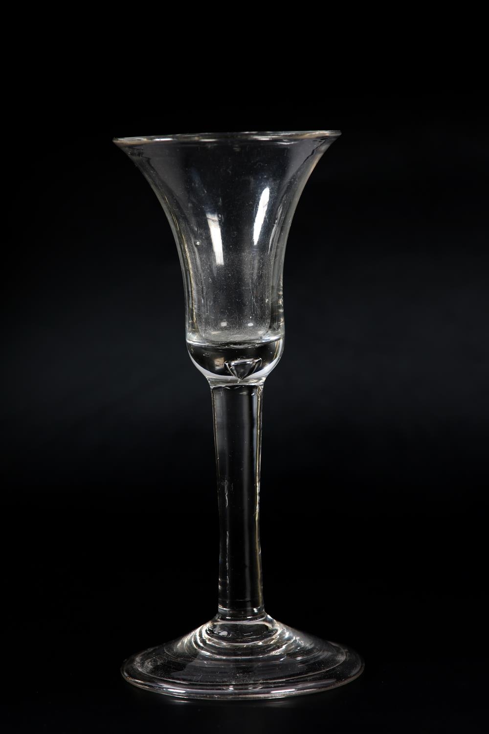 An 18th century wine glass, c1780, the ogee bowl etched with flower and leaves, on plain stem, domed - Image 2 of 5