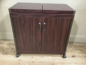 A wood effect metal hostess trolley together with a pine towel rail