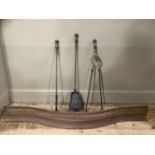 A set of 19th century steel fire irons and a steel curb of serpentine outline and pierced