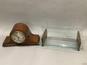 A 1930's mahogany mantle clock of arched profile silver dial with black Arabic numerals, eight day