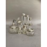 Twelve silver lidded and mounted dressing table items including five bottles, salts bottle, three