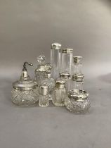 Twelve silver lidded and mounted dressing table items including five bottles, salts bottle, three
