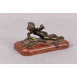 A late 19th century cold painted bronze figure of an infant girl and butterfly, on red marble