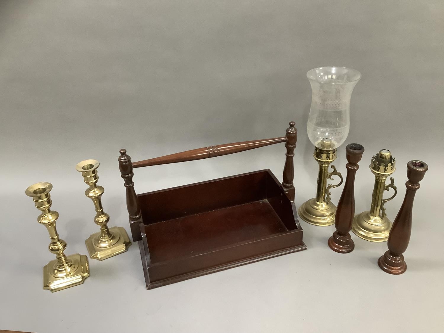 A reproduction book trough with carrying handle together with a pair of treen candlesticks, a pair