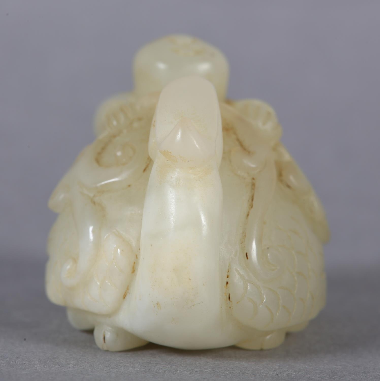 A Chinese jade carving of a boy climbing upon the back of a phoenix with its head turned backwards - Image 5 of 8