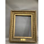 A 19th century giltwood picture frame with projecting moulding, acanthus leaf surround and egg and