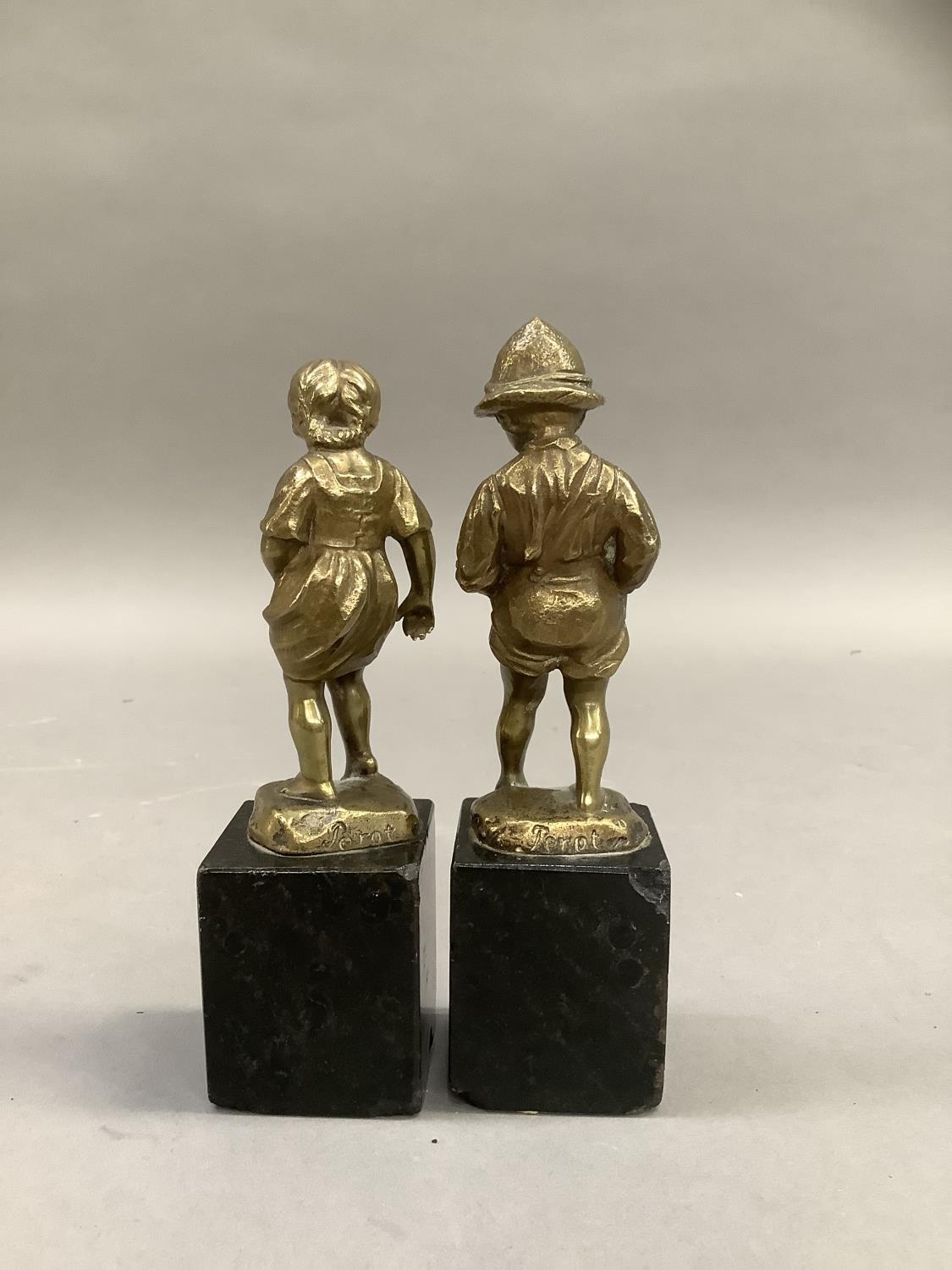 After Perot, a pair of 19th century brass sculptures of a boy and girl paddling raised on black - Image 2 of 3