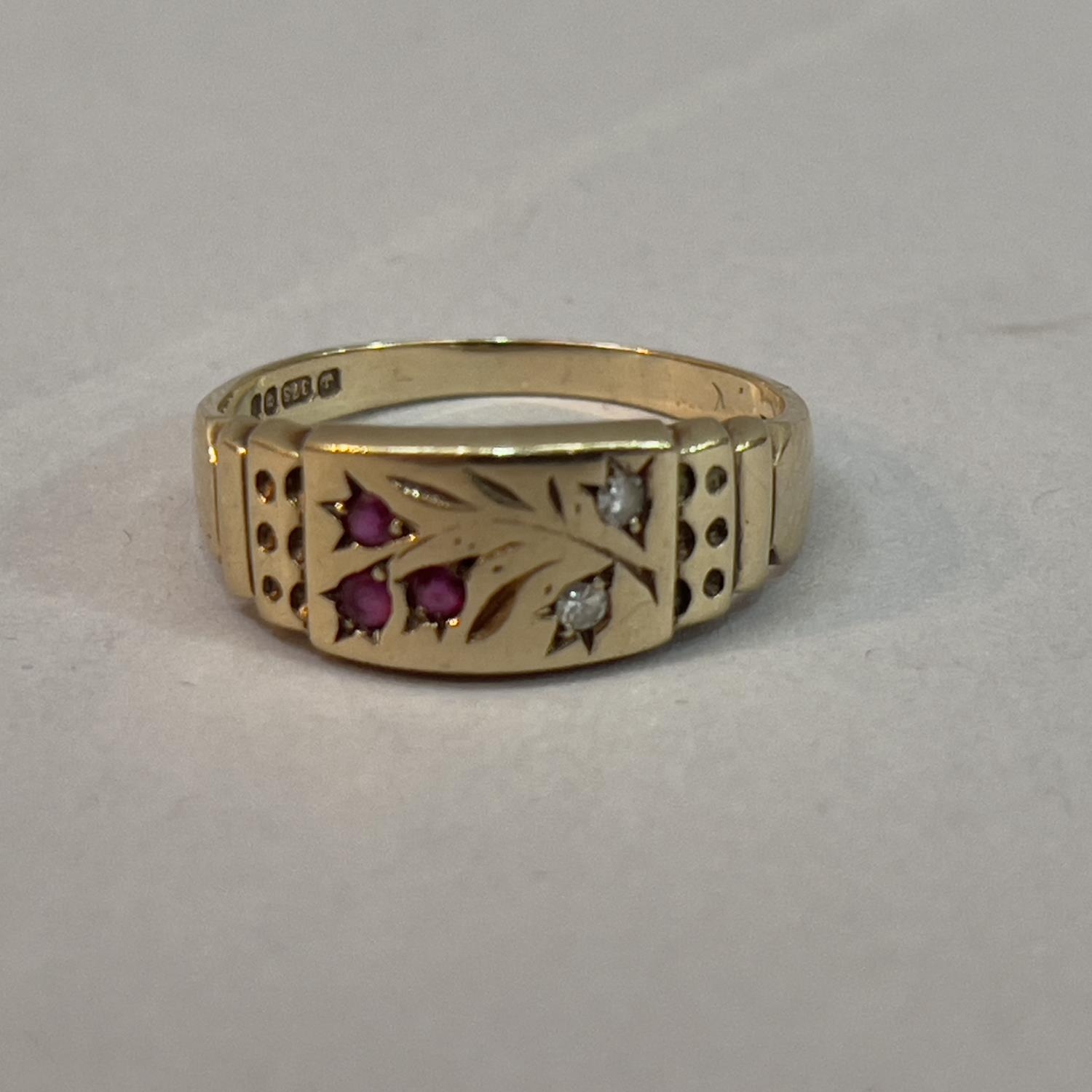 A ruby and diamond ring in 9ct gold, the small circular facetted rubies and eight cut diamonds,