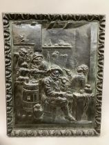 A metal advertising plaque embossed with a tavern scene with the wording: Les Delices de Flanards,