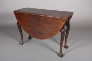 A George III mahogany pembroke dining table, oval, having twin drop leaves, arched apron, on