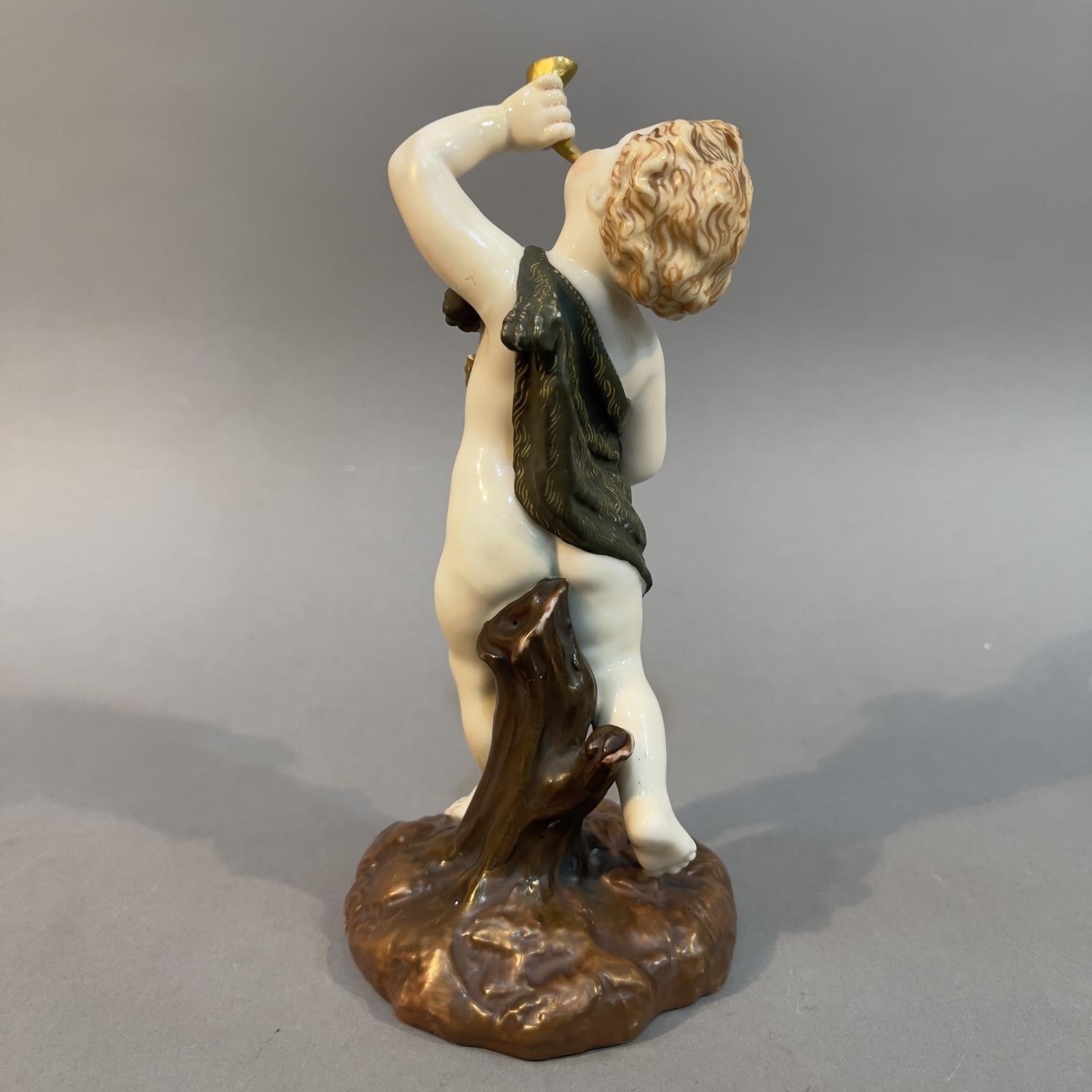 A Royal Worcester figure of a dancing cupid, holding a horn to his lips, on naturalistic base, - Image 2 of 3