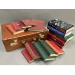 A tan leather briefcase together with a small quantity of books including History of Harrogate,