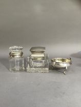 A silver cream jug, Chester 1922 together with a silver lidded glass inkwell of square outline