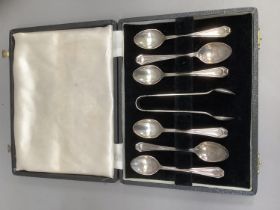 A George V art deco set of six silver coffee spoons and sugar tongs, Birmingham 1920 for Arthur