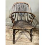 A 19th century elm and ash low back Windsor armchair, turned legs joined by a crinoline stretcher