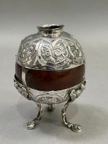 A Victorian polished coconut shell mounted with silver plated collar and cupped base on three