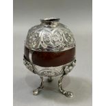 A Victorian polished coconut shell mounted with silver plated collar and cupped base on three