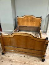 A 19th century continental birdseye maple and ebonised bedstead of double size having a semi