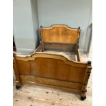 A 19th century continental birdseye maple and ebonised bedstead of double size having a semi